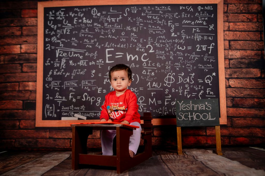 enfant devant un tableau de formule mathématique